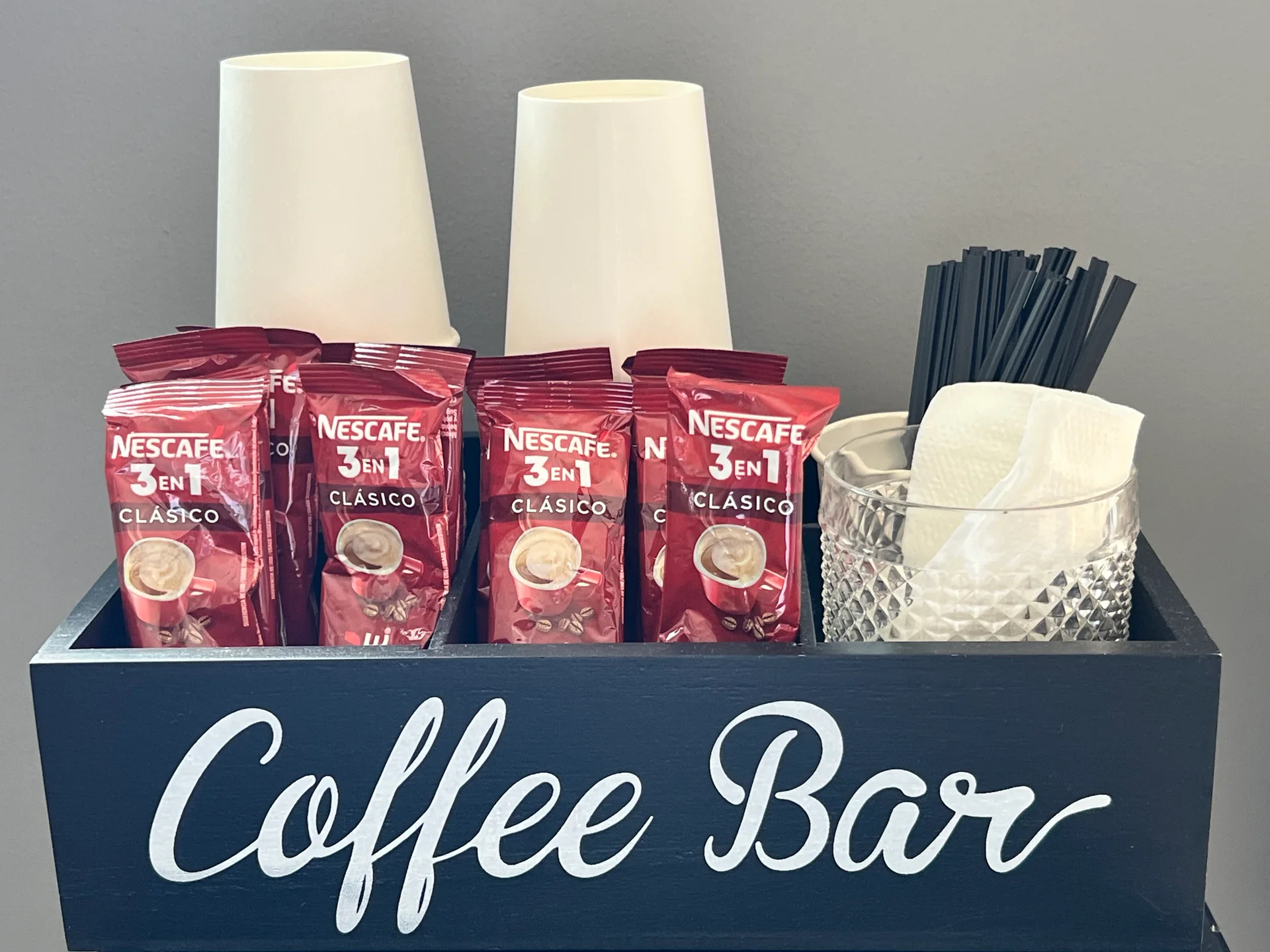 The Elite Smiles coffee bar with coffee sachets, cups and stirrers