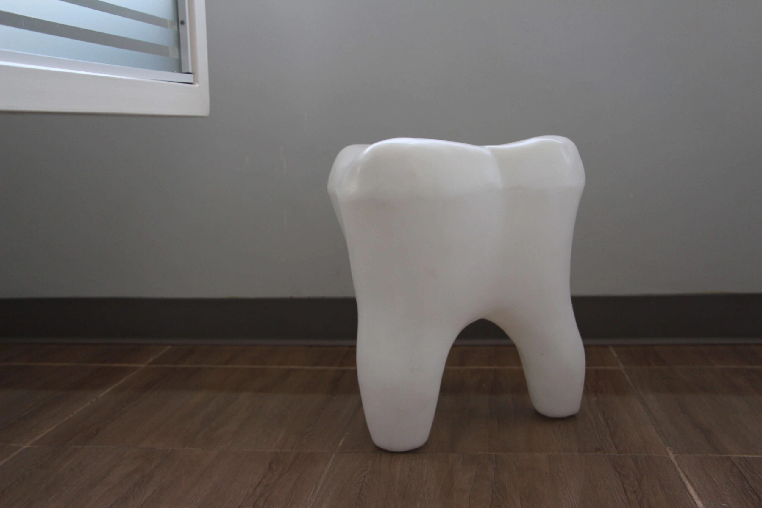 A tooth-shaped stool inside the Elite Smiles practice